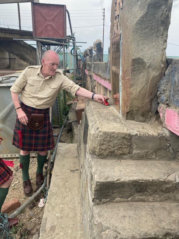 Ian Nivison lays poppies at the Cameron Memorial in Kohima 